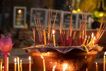 Burning incense sticks in a Buddhist Temple in Thailand.