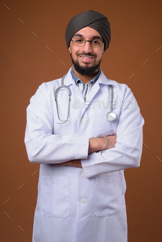 Youthful bearded Indian Sikh person physician carrying turban